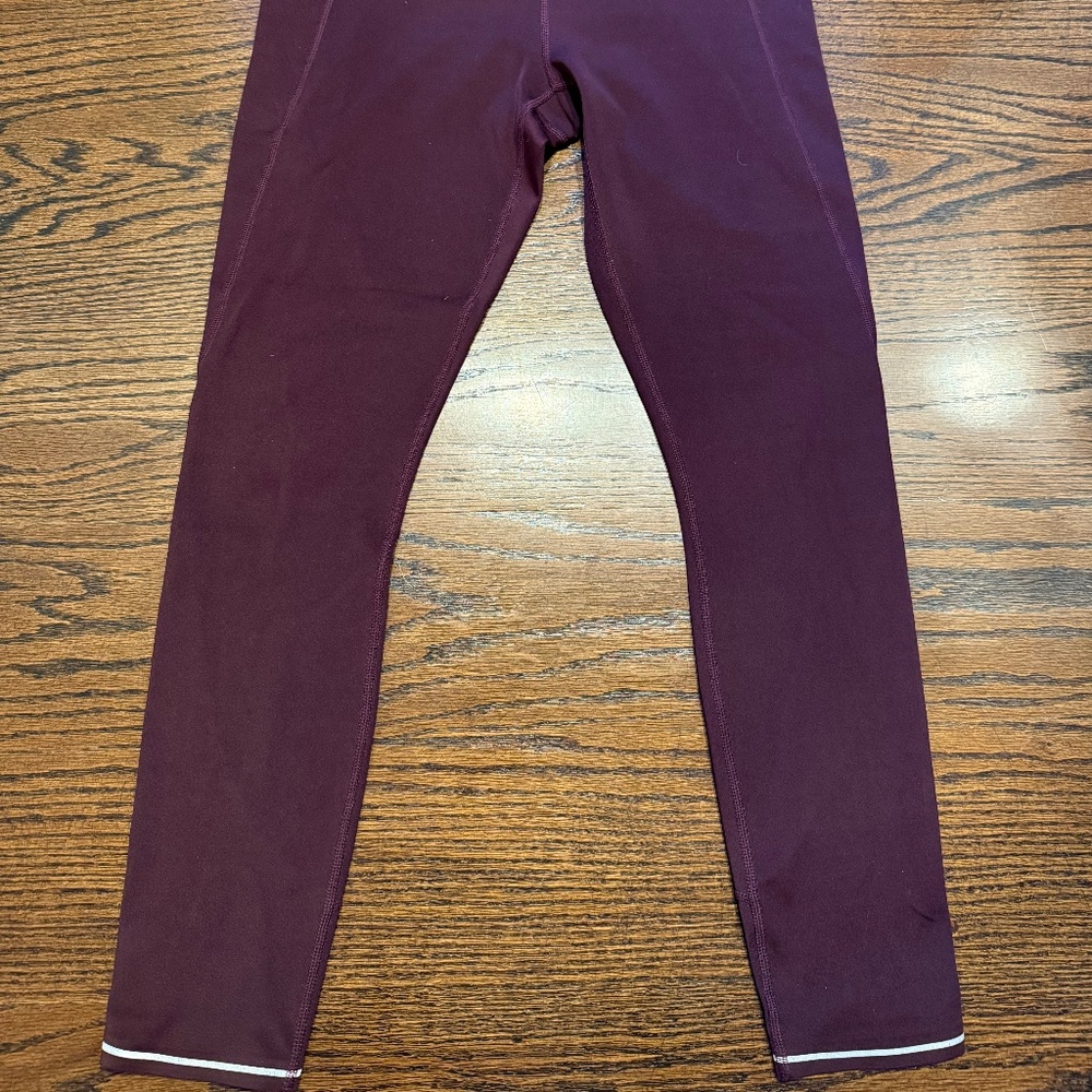 ATHLETA burgundy capri leggings with white lined bottoms